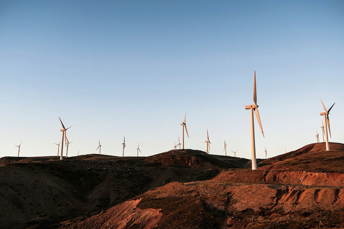 white wind turbines during daytime